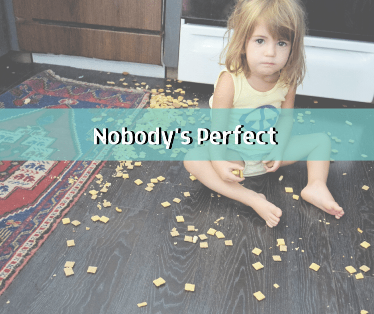 little girl sitting on floor surrounded by cracker crumbs